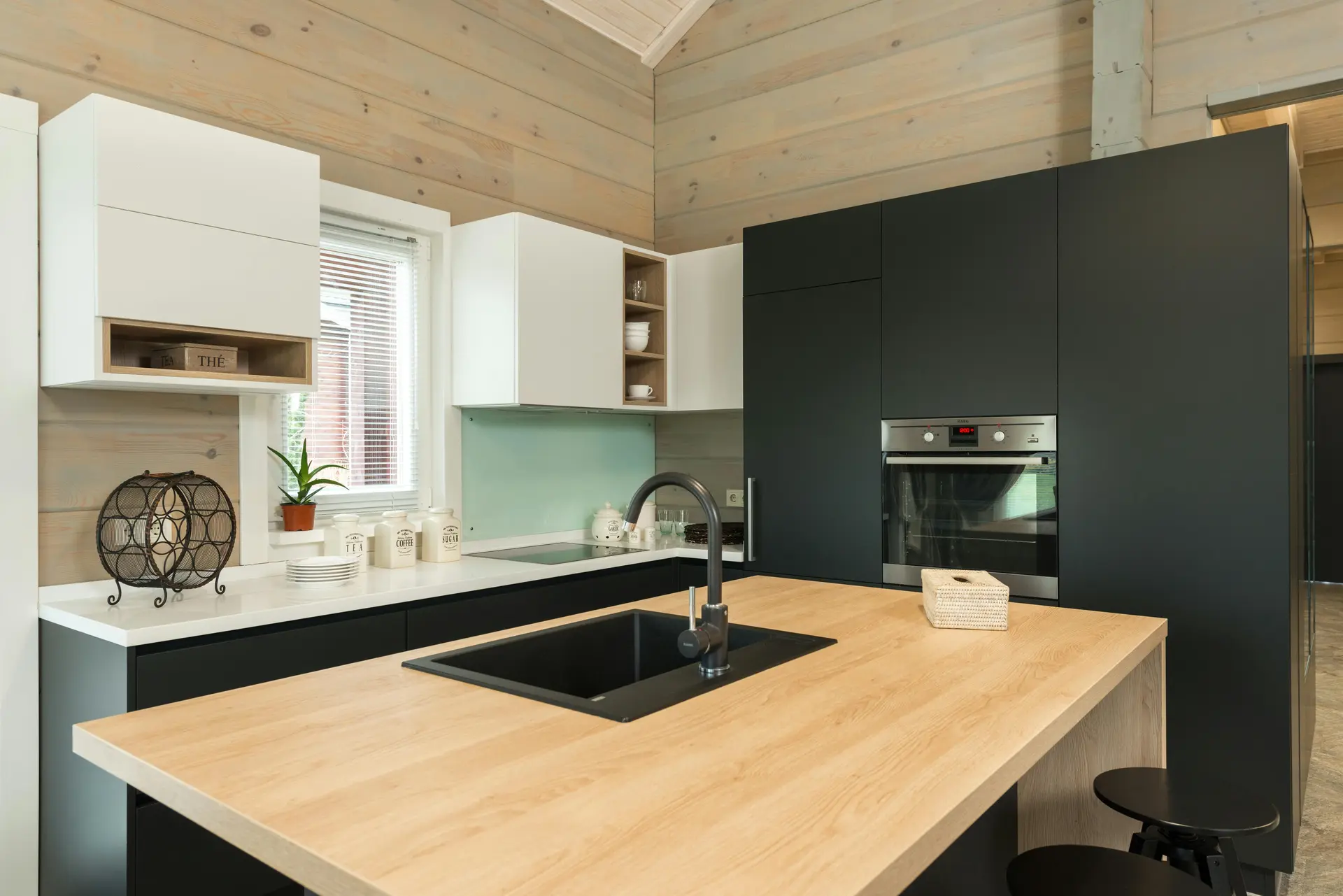 Modern kitchen with dark joinery and stone worktops